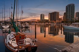 Harbor at Dusk A sailboat moored in Clearwater Harbor at dusk with calm reflections and the downtown skyline glowing in the background.